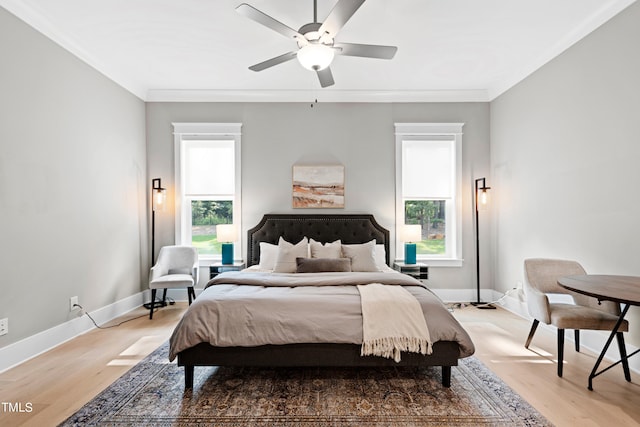 bedroom with wood-type flooring, crown molding, and ceiling fan