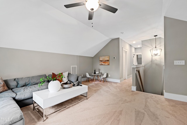 living room with lofted ceiling, ceiling fan, and light colored carpet