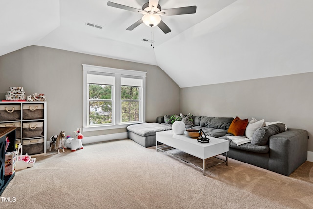 living room with ceiling fan, lofted ceiling, and carpet