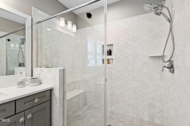 bathroom with vanity and a shower with door