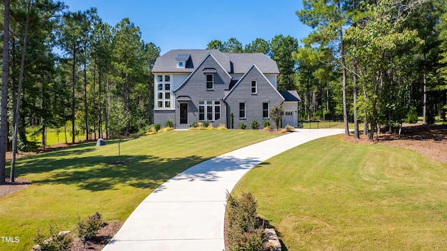 view of front of property with a front lawn and a garage