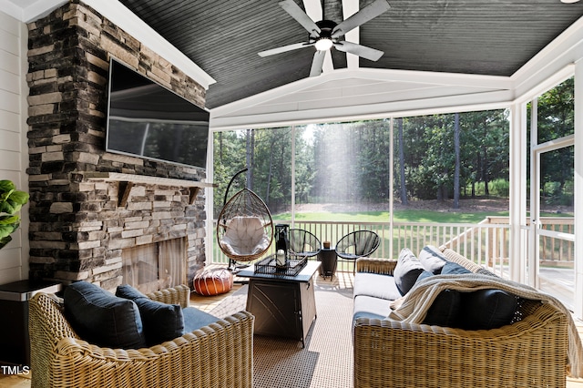 sunroom / solarium featuring ceiling fan, vaulted ceiling, and a healthy amount of sunlight