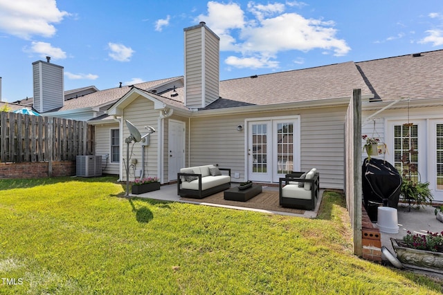 rear view of property with cooling unit, an outdoor living space, a yard, and a patio