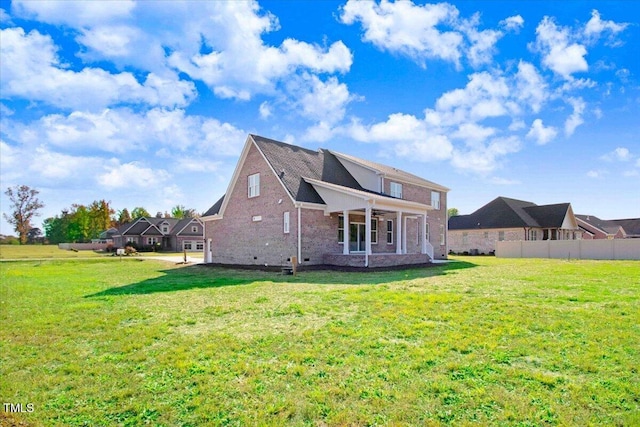 46 Otter Hole Dr, Kenly, NC 27542 - rear view of property featuring a yard, brick siding, ceiling fan, and fence