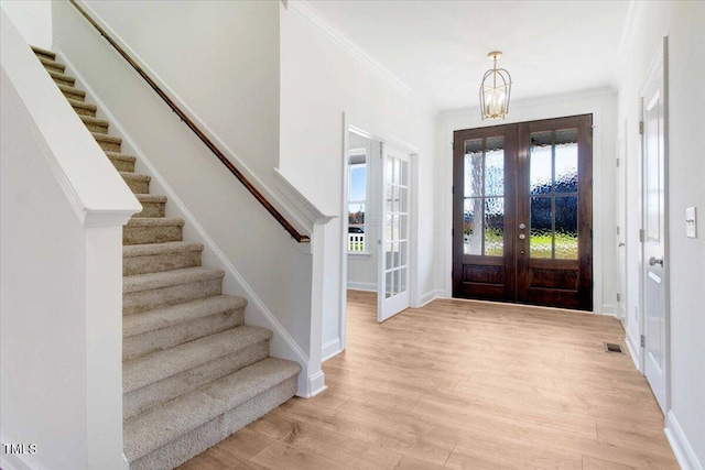 46 Otter Hole Dr, Kenly, NC 27542 - foyer with an inviting chandelier, baseboards, stairway, french doors, and light wood-style flooring
