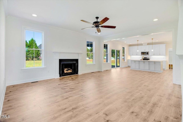 46 Otter Hole Dr, Kenly, NC 27542 - unfurnished living room featuring a ceiling fan, visible vents, a fireplace, light wood-type flooring, and baseboards