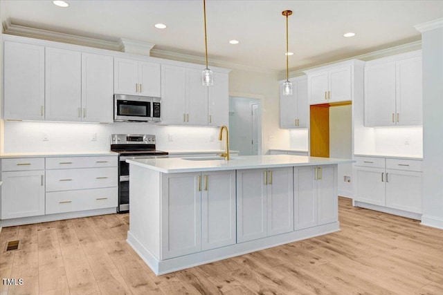46 Otter Hole Dr, Kenly, NC 27542 - kitchen featuring a sink, an island with sink, stainless steel appliances, light wood-type flooring, and tasteful backsplash