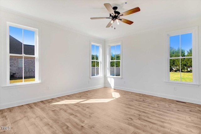46 Otter Hole Dr, Kenly, NC 27542 - spare room featuring crown molding, a ceiling fan, baseboards, light wood-type flooring, and visible vents
