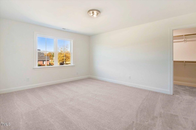 46 Otter Hole Dr, Kenly, NC 27542 - unfurnished bedroom with baseboards, light carpet, a walk in closet, and a closet