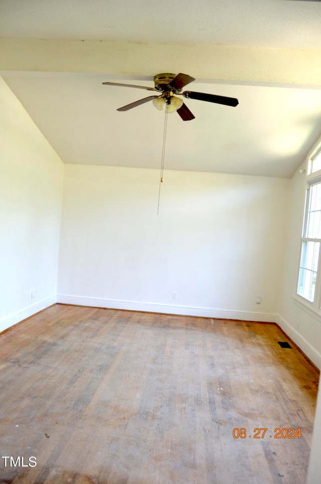 unfurnished room with ceiling fan, light hardwood / wood-style floors, and vaulted ceiling