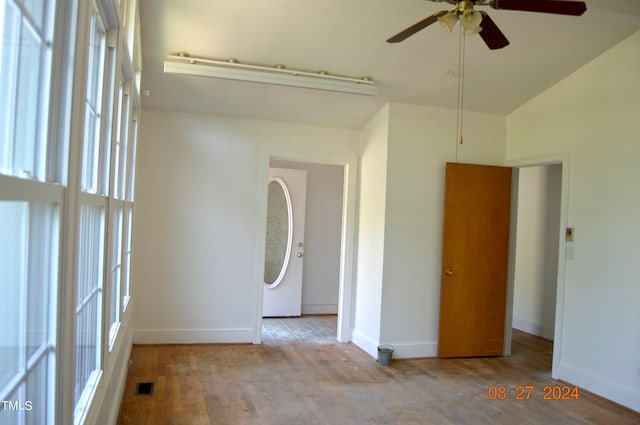 interior space with light hardwood / wood-style flooring, ceiling fan, and high vaulted ceiling