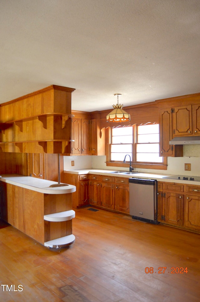 kitchen featuring cooktop, decorative light fixtures, dishwasher, sink, and light hardwood / wood-style floors