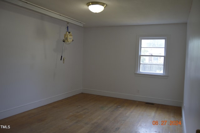 spare room with hardwood / wood-style floors