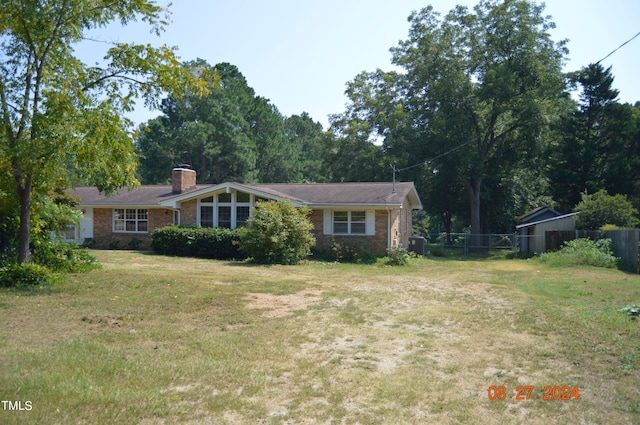 single story home featuring central AC and a front yard