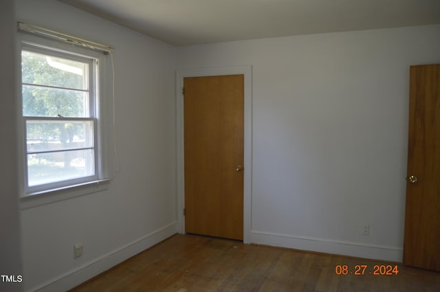 unfurnished room with hardwood / wood-style flooring