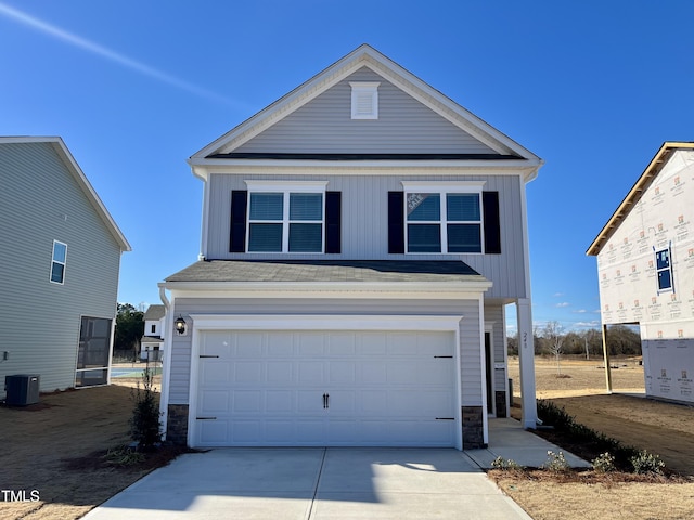 view of front of property featuring central AC and a garage