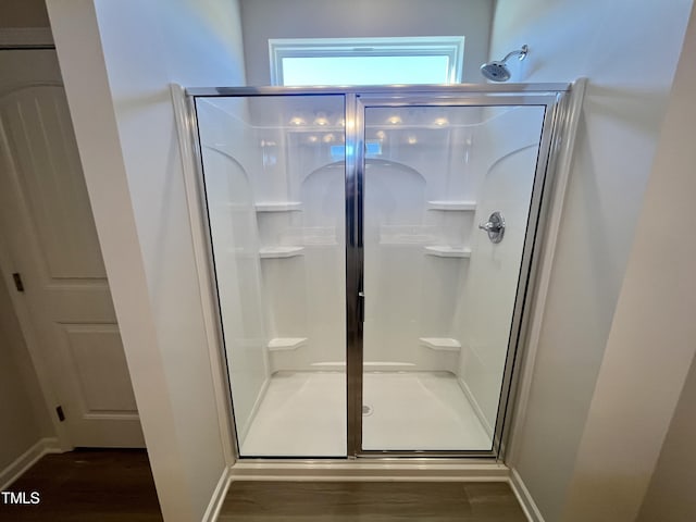 bathroom featuring hardwood / wood-style floors and an enclosed shower