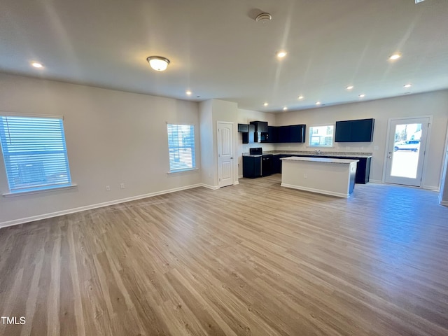 kitchen with a kitchen island and light hardwood / wood-style floors