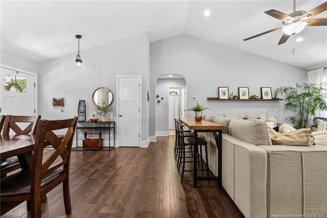 living room with high vaulted ceiling, dark hardwood / wood-style floors, and ceiling fan