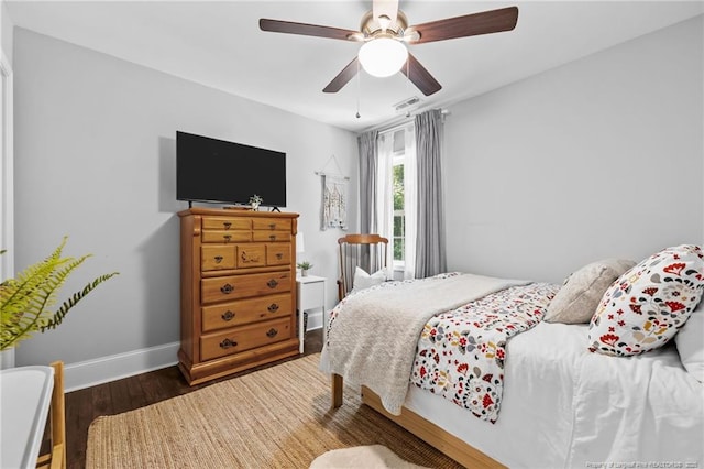 bedroom with ceiling fan and dark hardwood / wood-style floors