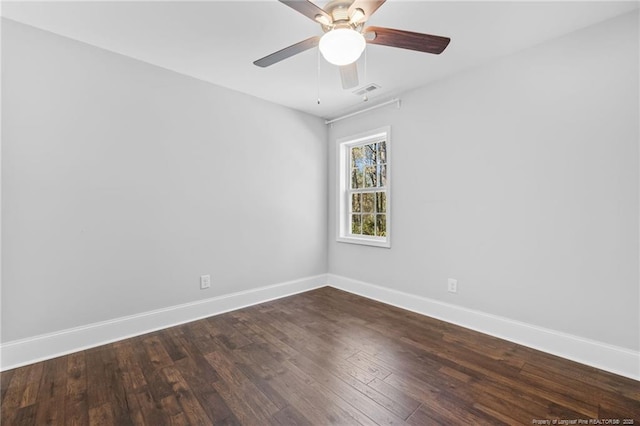 unfurnished room with dark hardwood / wood-style floors and ceiling fan