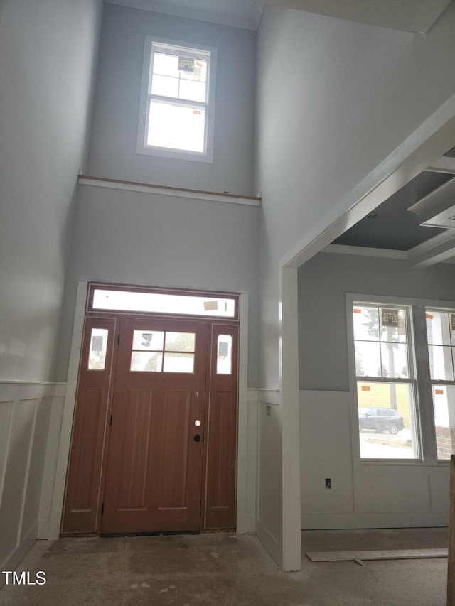 entrance foyer featuring plenty of natural light and concrete floors