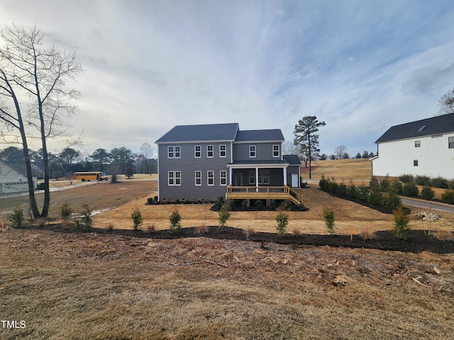 back of house featuring a sunroom