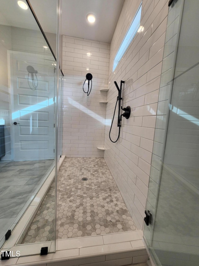 full bath with a stall shower and tile patterned floors