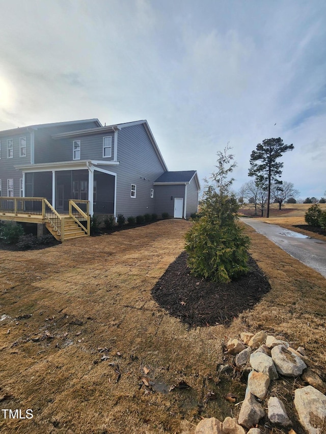 view of home's exterior with a sunroom