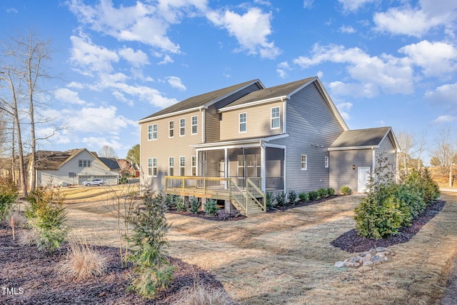 rear view of property with a sunroom