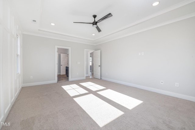 unfurnished bedroom with light carpet, baseboards, a raised ceiling, ornamental molding, and recessed lighting