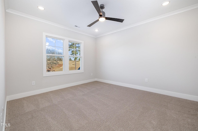 spare room with carpet floors, recessed lighting, crown molding, and baseboards