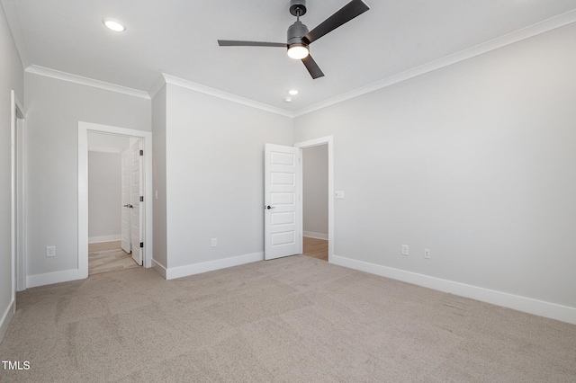 unfurnished bedroom featuring crown molding, carpet flooring, and baseboards