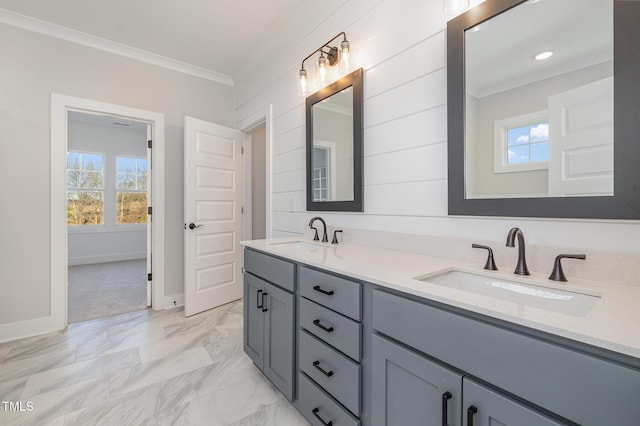 bathroom featuring plenty of natural light, a sink, and crown molding