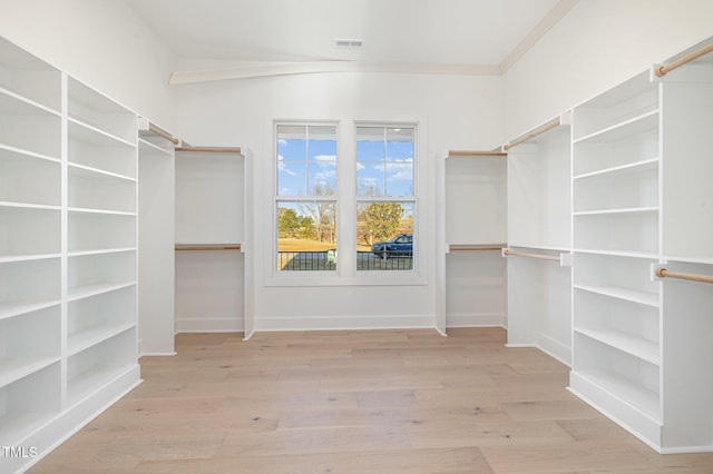 walk in closet with visible vents and wood finished floors