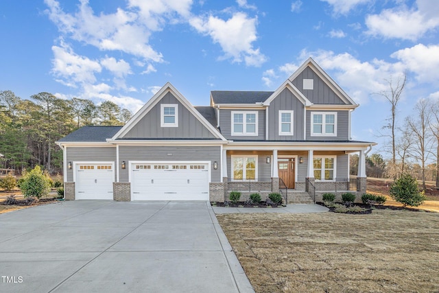 craftsman inspired home featuring brick siding, a porch, concrete driveway, an attached garage, and board and batten siding