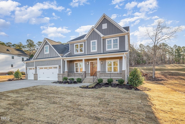 craftsman inspired home with board and batten siding, covered porch, brick siding, and driveway