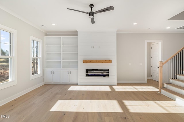 unfurnished living room with stairway, baseboards, ornamental molding, and light wood finished floors