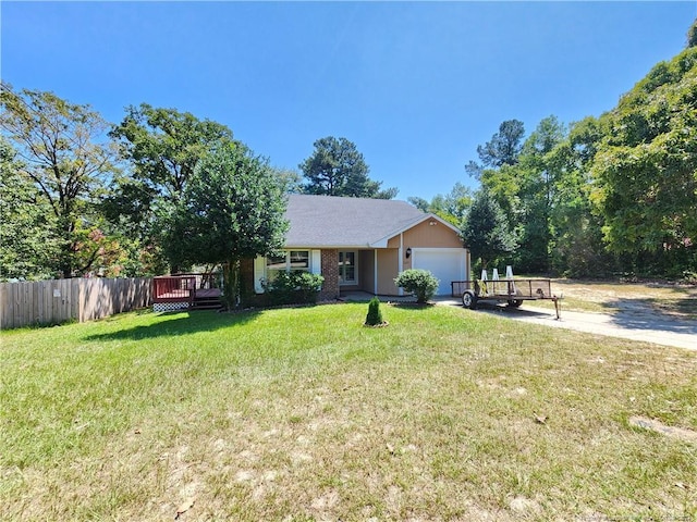 view of front of home featuring a front yard, a wooden deck, and a garage