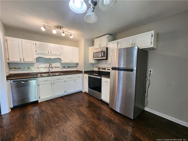 kitchen with dark hardwood / wood-style flooring, stainless steel appliances, sink, and white cabinets