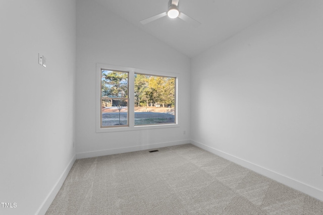 unfurnished room with visible vents, baseboards, a ceiling fan, light colored carpet, and vaulted ceiling