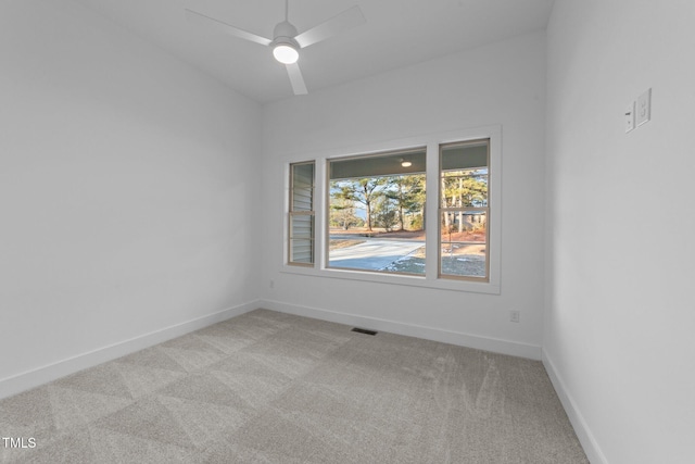 unfurnished room featuring ceiling fan, carpet, visible vents, and baseboards