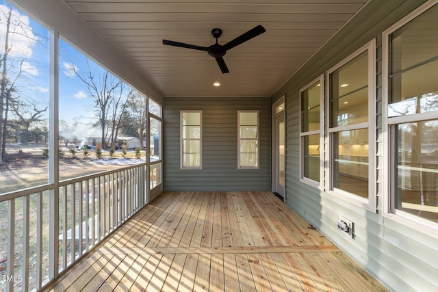 unfurnished sunroom with ceiling fan