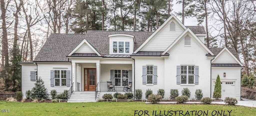 view of front of house featuring a front yard, a garage, and a porch