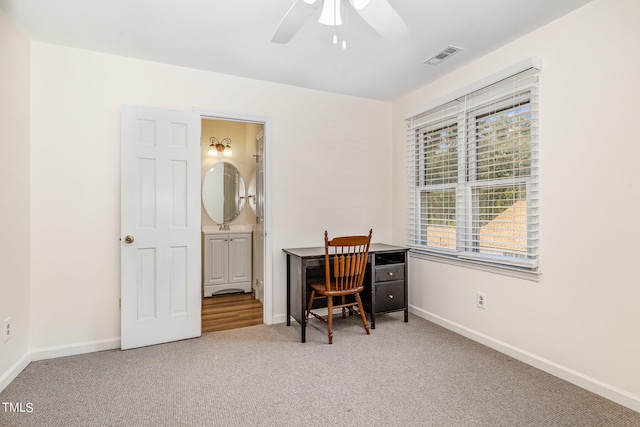 carpeted office with ceiling fan