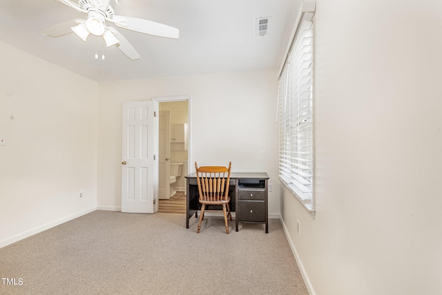 office featuring light carpet and ceiling fan