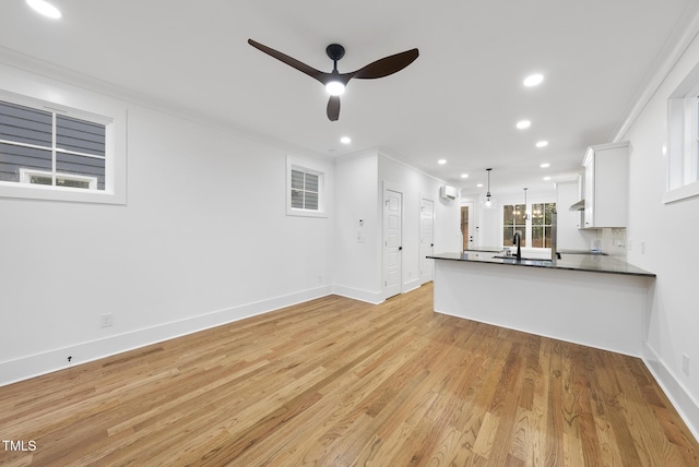 unfurnished living room with light wood-style floors, recessed lighting, crown molding, and ceiling fan