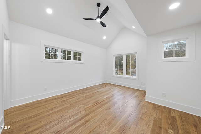 spare room with recessed lighting, vaulted ceiling, light wood-style flooring, and baseboards