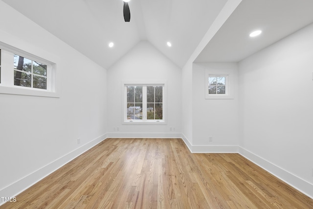 spare room featuring lofted ceiling, ceiling fan, recessed lighting, baseboards, and light wood-type flooring