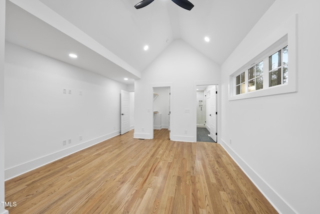 unfurnished bedroom with lofted ceiling, recessed lighting, baseboards, a spacious closet, and light wood finished floors